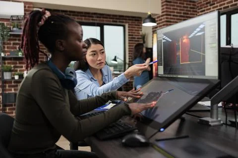 Digital interactive entertainment industry workers working with CGI. Stock Photos