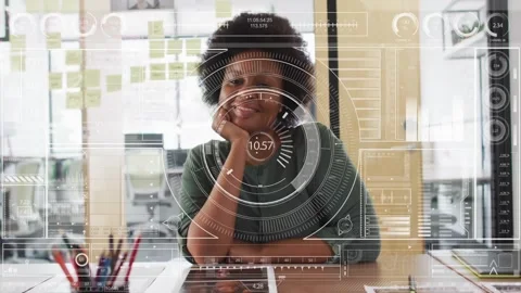 Digital interface with data processing over woman sitting at desk in office Stock Footage 329989543