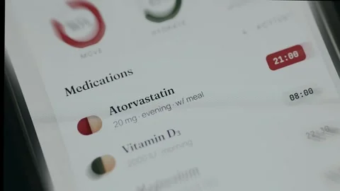 Digital interface tracking a medication schedule for Atorvastatin and Vitamin D3 Stock Footage 335893197