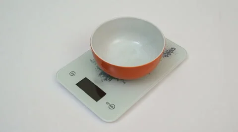 Digital kitchen scale and a bowl with sugar Stock Footage 49764225