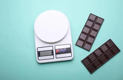 Digital kitchen scale with chocolate bars on pastel background Stock Photos