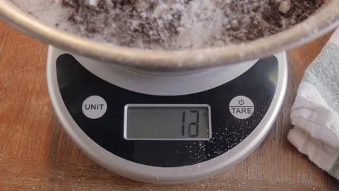 A Digital Kitchen Scale Measures Pastry Ingredients by Weight - 4K Stock Footage 76586295