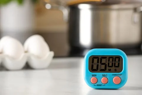 Digital kitchen timer on white table indoors. Space for text Stock Photos