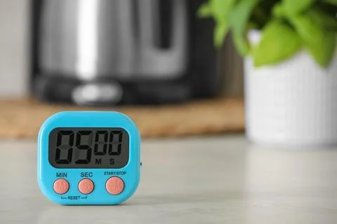 Digital kitchen timer on white table indoors. Space for text Stock Photos