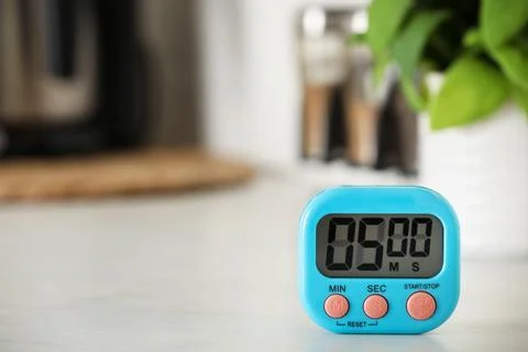 Digital kitchen timer on white table indoors. Space for text Stock Photos