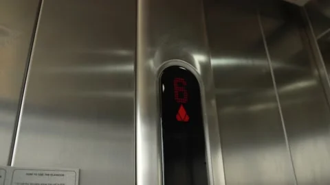 Digital LED display with number and arrows inside elevator with steel cabin. Stock Footage 233522471