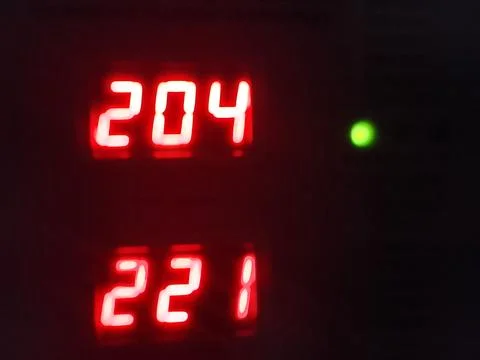 Digital led display showing numeric readings in red with electronic indicator Stock-Fotos