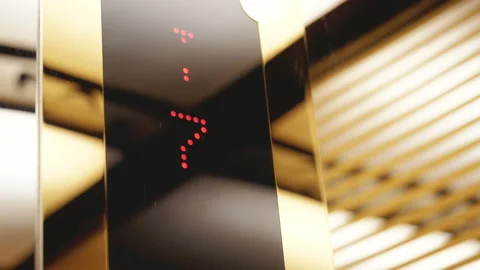Digital LED sign in an elevator counting from ten to one with an arrow Stock Footage 148615023
