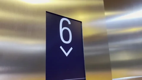 Digital LED sign in elevator counting from 9 to 2 with a white arrow Stock Footage 254053621