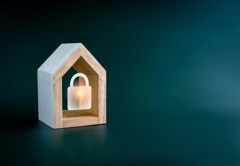 Digital lock icon glowing in simple miniature wooden house isolated on gree.. Fotos de archivo