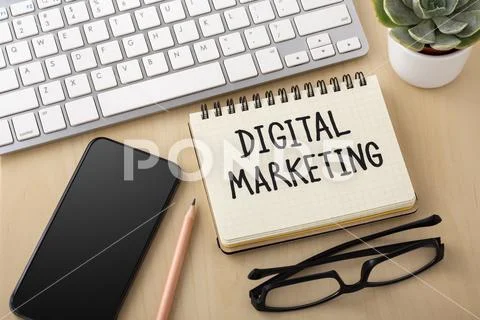 Digital marketing concept with smartphone and computer keyboard on wooden des Stock Photos