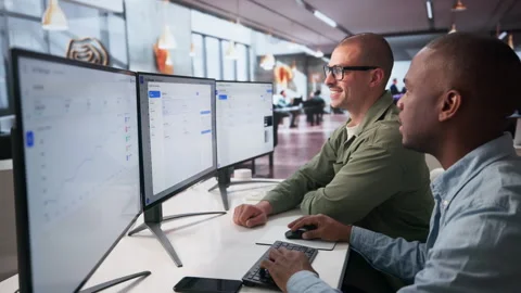 Digital Marketing Managers Analyze Online Ad Campaign Results Together Stock Footage 335451225