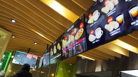 Digital menu shines above counter in vibrant roadside cafe Stockbeeldmateriaal 308948741