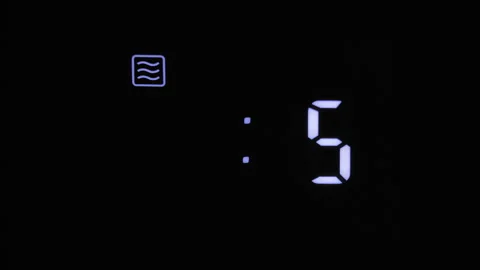 Digital microwave oven display counts from ten seconds to zero Stock Footage 336566263