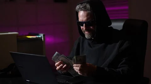 Digital money thief. Hacker programmer in hoodie at office laptop, gaming Stock-Footage 322026117
