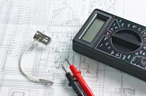 Digital multimeter and  lamp Stock Photos