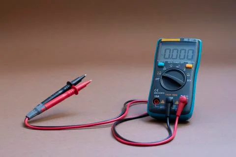 Digital multimeter on brown background Stock Photos