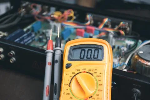 Digital multimeter for checking voltage and electronics part inspection Stock Photos