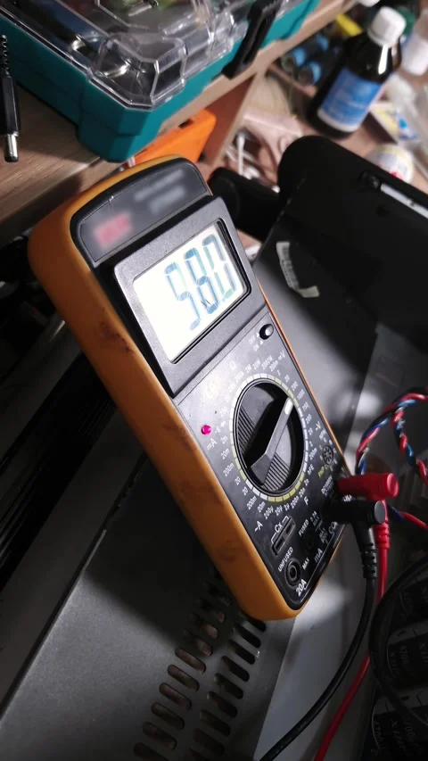 Digital Multimeter Displaying Numeric Reading on Electronics Repair Workbench Stock Footage 339001817