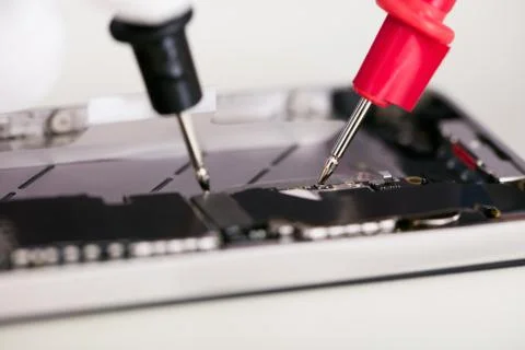 Digital Multimeter Probes Testing Mobile Phone Stock Photos