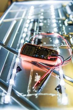 Digital multimeter testing led backlight strips inside flat screen television 스톡 사진