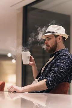 Digital nomad burning himself with a cup of tea while working. Lifestyle conc Stock Photos