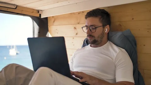 Digital nomad life telecommuting in a van by the ocean Видео 291902899