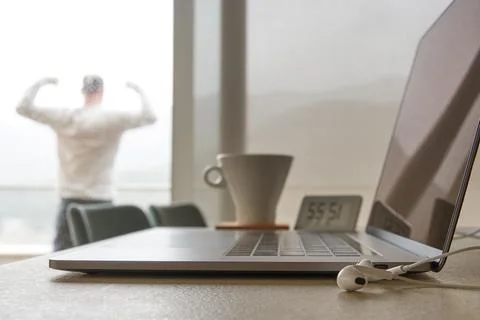 Digital nomad man finished work and celebrating on the balcony Stock Photos