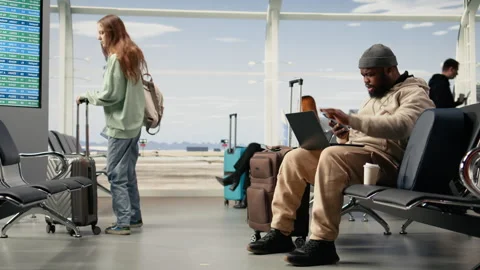 Digital nomad professional waiting for delayed flight in airport lounge Video stock 333167391