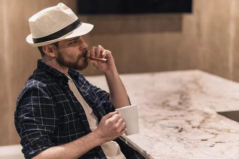 Digital nomad thinking about his projects drinking coffee and smoking vape... Stock Photos