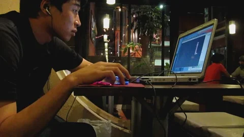 Digital nomad using laptop in cafe Stock Footage 159516905