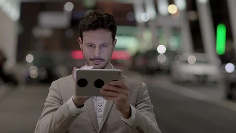 Digital Nomad Working on the go in the City Searching the Web on Computer Device Stock Footage 98553868