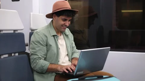 Digital nomad working on laptop while traveling by train, 4k video Stock Footage 298562316