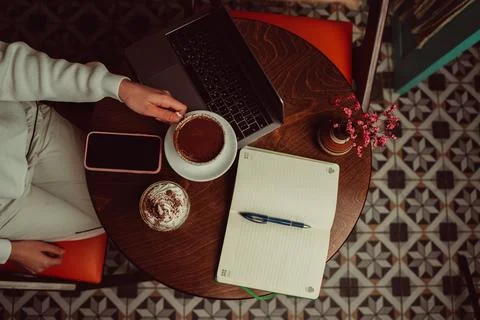 Digital nomad working online from a cafe table Stock Photos