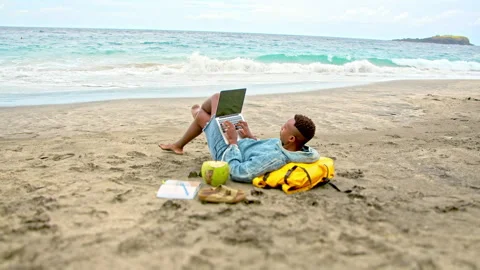 Digital nomad working at sea beach. African american man use laptop. Black guy. Stock Footage 246407526
