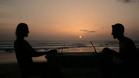 Digital nomads couple working on laptops by sunset Stock Footage 61139355