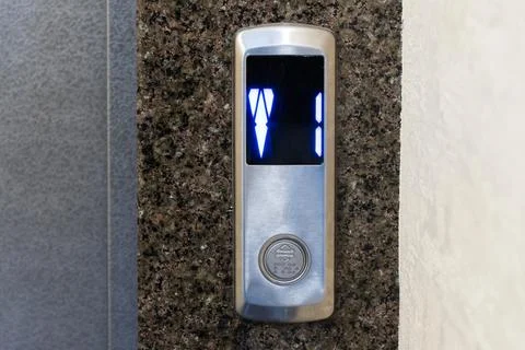 Digital numbers illuminate as the elevator waits for passengers in a modern.. Stock Photos