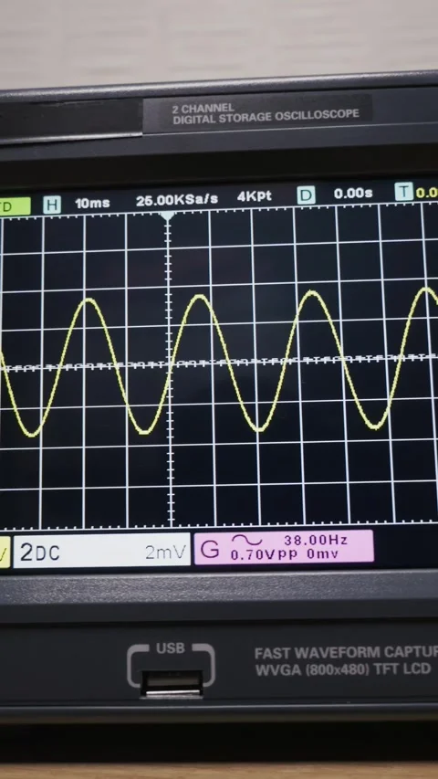Digital Oscilloscope Screen Displaying a Yellow Sine Wave Analysis Stock Footage 327713512