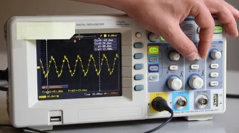 Digital oscilloscope switched on by an hand. Stock-Footage 66588307