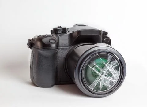 Digital reflex camera with the front lens broken. Stock Photos