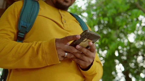 Digital savvy hiker using smartphone amid verdant forest, merging technological Stock Footage 314295388