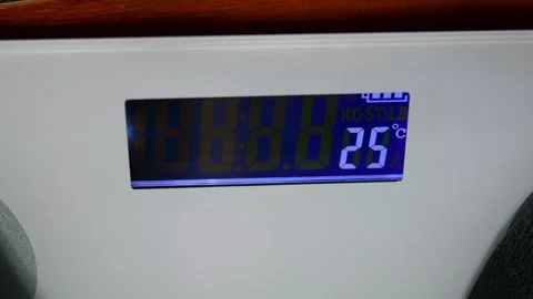 Digital scale display showing over 100kg, symbolizing obesity problem Stock Footage 321750166