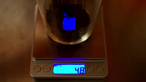 Digital Scale Measuring Material Added Into Glass Container Close Up Stock Footage 333282689