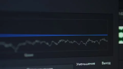 Digital screen displaying audio waveform analysis with blue reference line Stock Footage 347477252