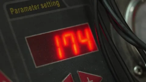 A digital screen displaying red illuminated numbers on testing equipment. Stock Footage 342262727