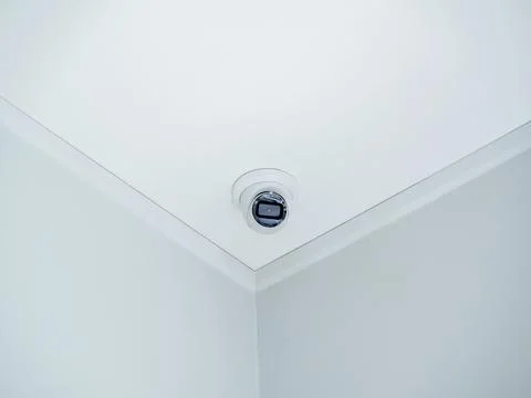 Digital security eye. A white round indoor CCTV surveillance camera monitor.. Stock Photos