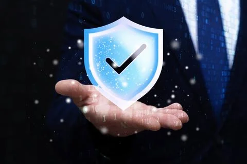 Digital security shield with check mark above businessman hand on dark bina.. Stock Photos