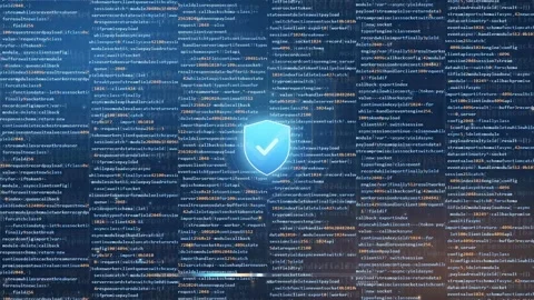 Digital security shield icon glowing over scrolling computer code for Stock Footage 341823739