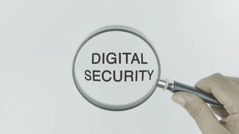 Digital Security text or word highlighted by a magnifying glass in a hand Stock Footage 303612430