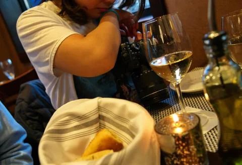 Digital single lens reflex camera on restaurant table as photographer reviews Stock Photos